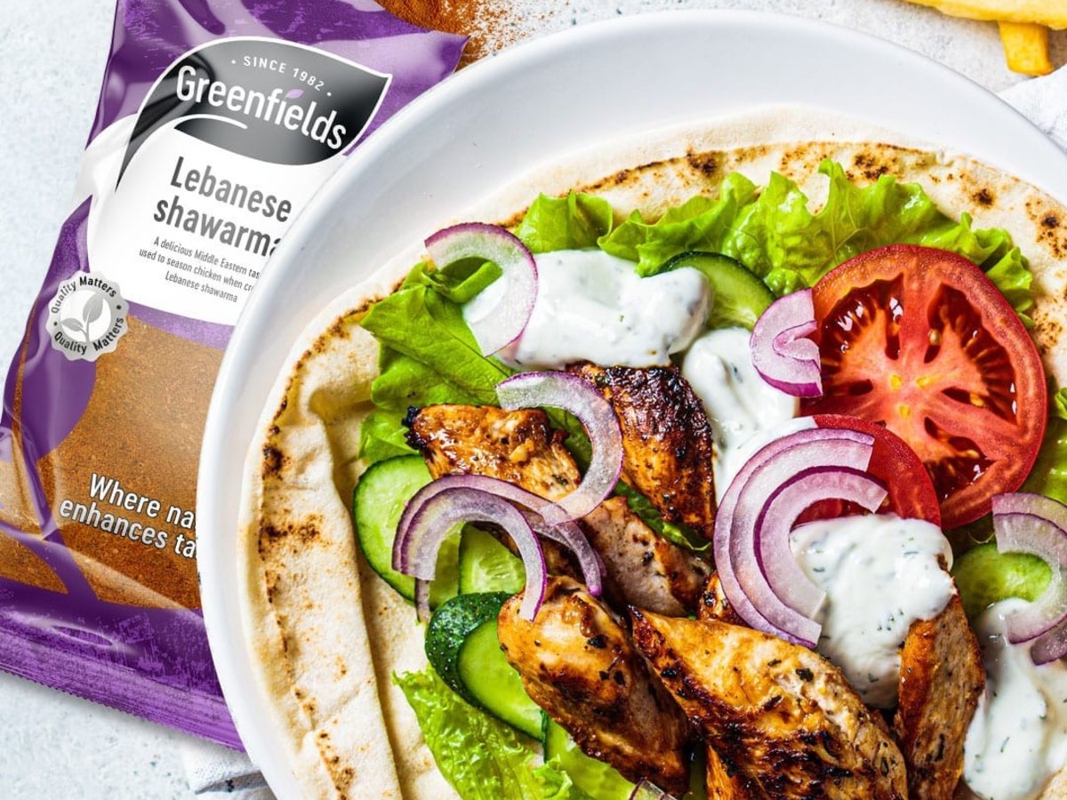 Chicken shawarma wrap with salad and garlic sauce, next to a pack of Greenfields Lebanese shawarma spice