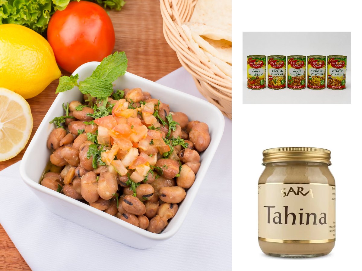 A bowl of fava beans topped with chopped tomato and mint, with lemons and flatbread, beside California Garden ful medames tins and a jar of tahina