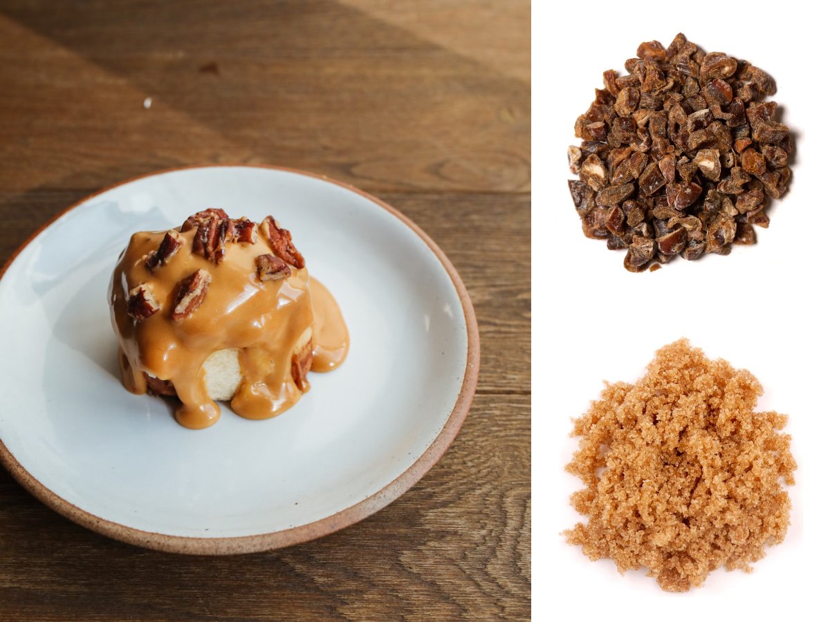 A sticky toffee pudding with toffee sauce and pecans on a white plate, with Sara chopped dates and brown sugar