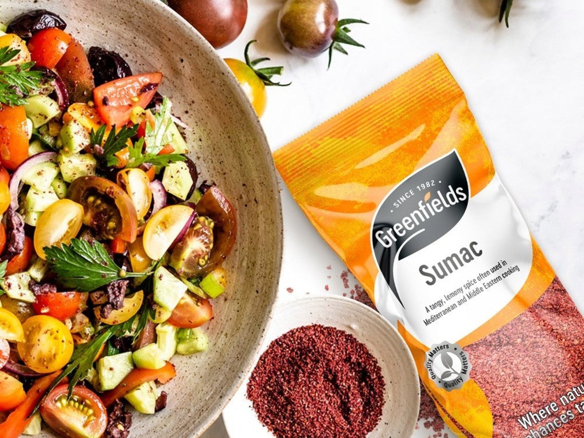 Tomato and cucumber salad with a dish of ground sumac and a pack of Greenfields Sumac