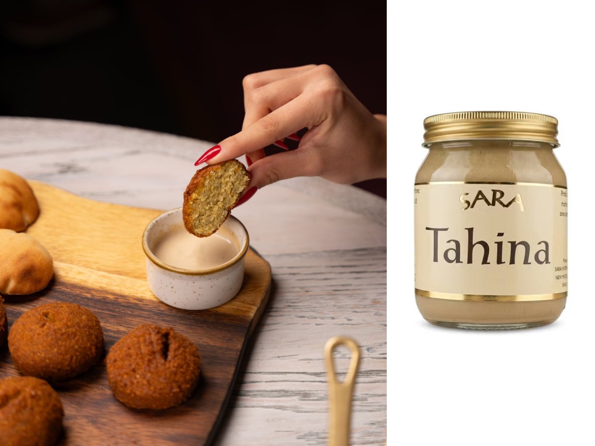 Falafel dipped into tahini sauce, with a jar of Sara Tahina sesame paste