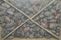 Top view of Al-Quds Medjool dates packed in a divided tray
