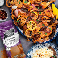 Roast chicken with lemons beside a Greenfields Lebanese 7 spice pack