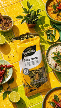 Greenfields dried curry leaves pack with curries on a yellow table