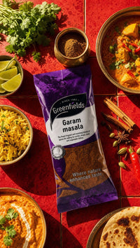Greenfields garam masala pack with curries and rice on a red background