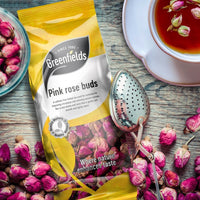 Greenfields pink rose buds pack with a cup of rose tea