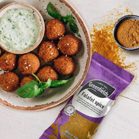 Falafel with a yoghurt dip beside a Greenfields falafel spice pack