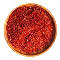 Wooden bowl of hot red chilli flakes