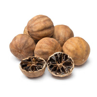 Whole and halved dried limes (loomi) showing the dark inside