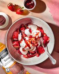 Strawberries with cream and sumac beside a Greenfields sumac pack