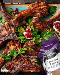 Grilled lamb chops with herbs and pomegranate beside a Greenfields Lebanese 7 spice pack