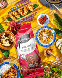 Greenfields bullet chilli pack among colourful Asian dishes