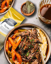 Slow-cooked beef with carrots beside a Greenfields thyme pack