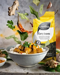 Greenfields dried curry leaves pack above a bowl of curry and rice