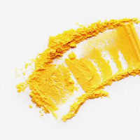 Swipe of bright yellow ground turmeric