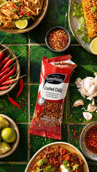 Greenfields crushed chillies pack with fresh chillies and spicy dishes