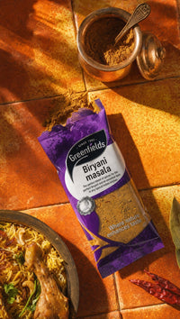 Greenfields biryani masala pack on an orange tiled background