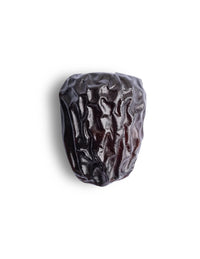 Close-up of a single dark Ajwa date