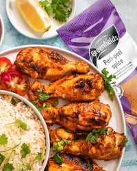 Peri-peri chicken drumsticks with rice beside a Greenfields pack