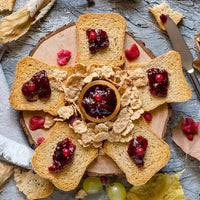Herfy rusk toasts arranged around a bowl of jam