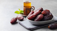 Palestinian Medjool dates on a plate with a glass of tea